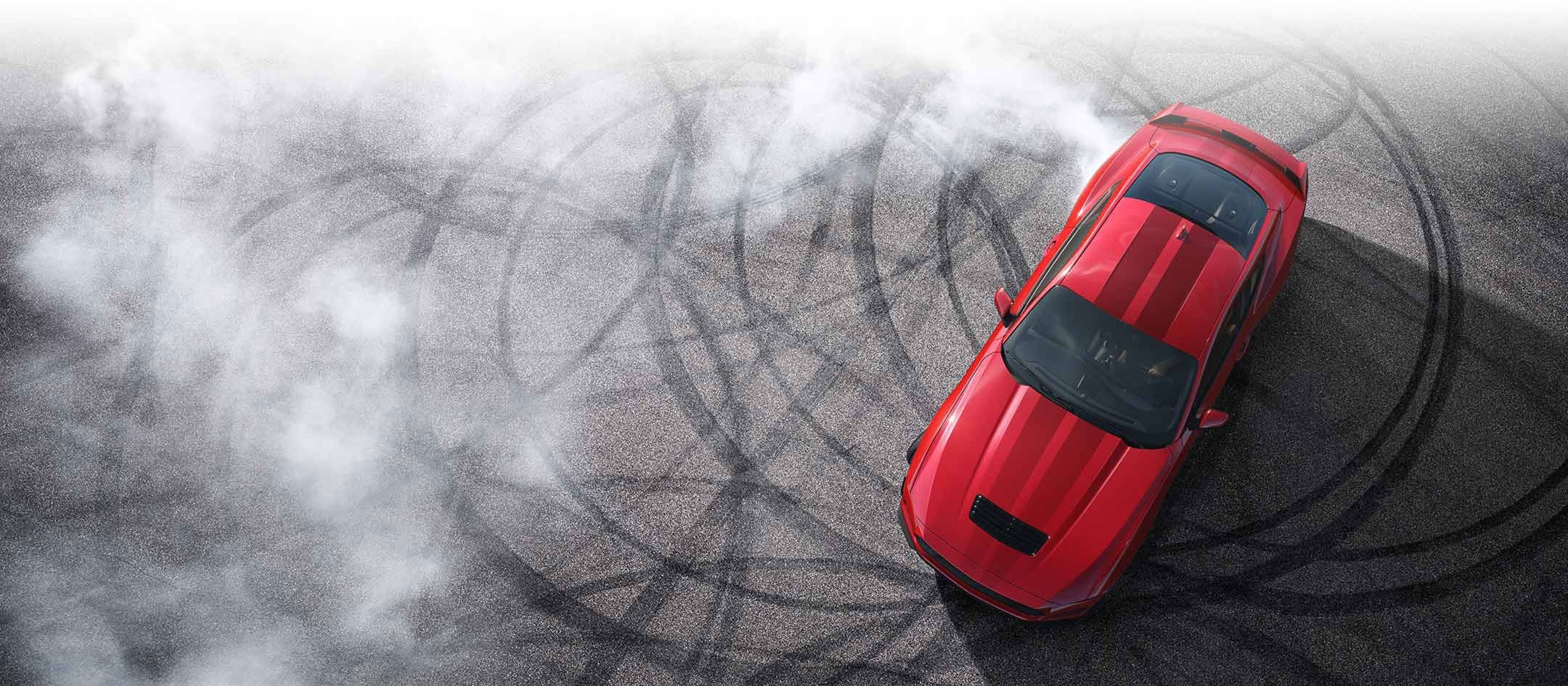 Overhead view of a 2024 Ford Mustang® model with tire tracks on pavement | Palm Coast Ford in Palm Coast FL