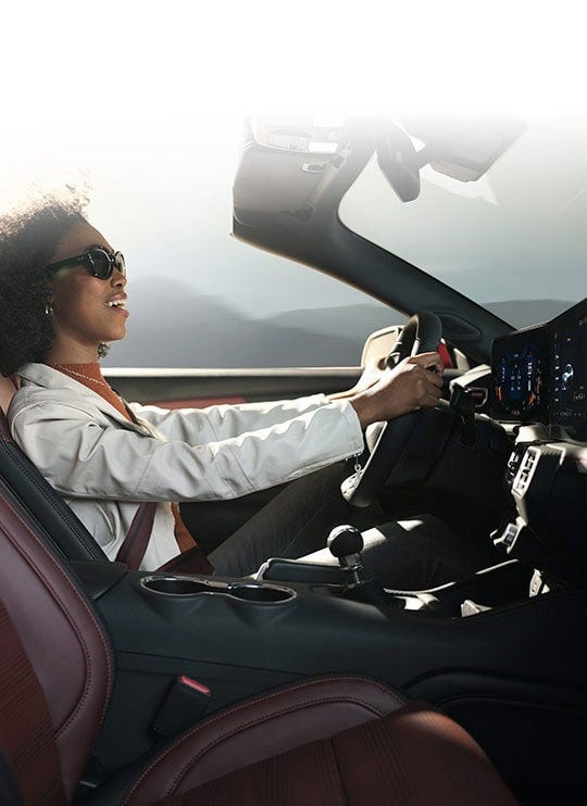 Person sitting in the driver’s seat of a 2024 Ford Mustang® convertible | Palm Coast Ford in Palm Coast FL