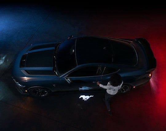 2024 Ford Mustang® Dark Horse™ model with a driver approaching the vehicle | Palm Coast Ford in Palm Coast FL